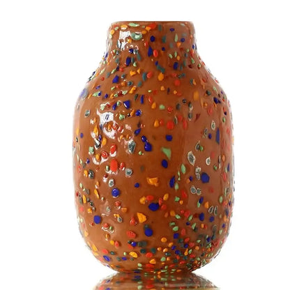 A decorbites glass vase featuring a glossy terracotta finish with vibrant multicolored glass flecks for home decor and plants