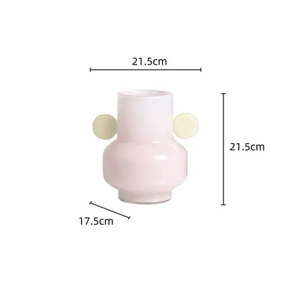 A sleek blush-pink ceramic decorbites glass vase with two cream spherical handles for floral arrangements