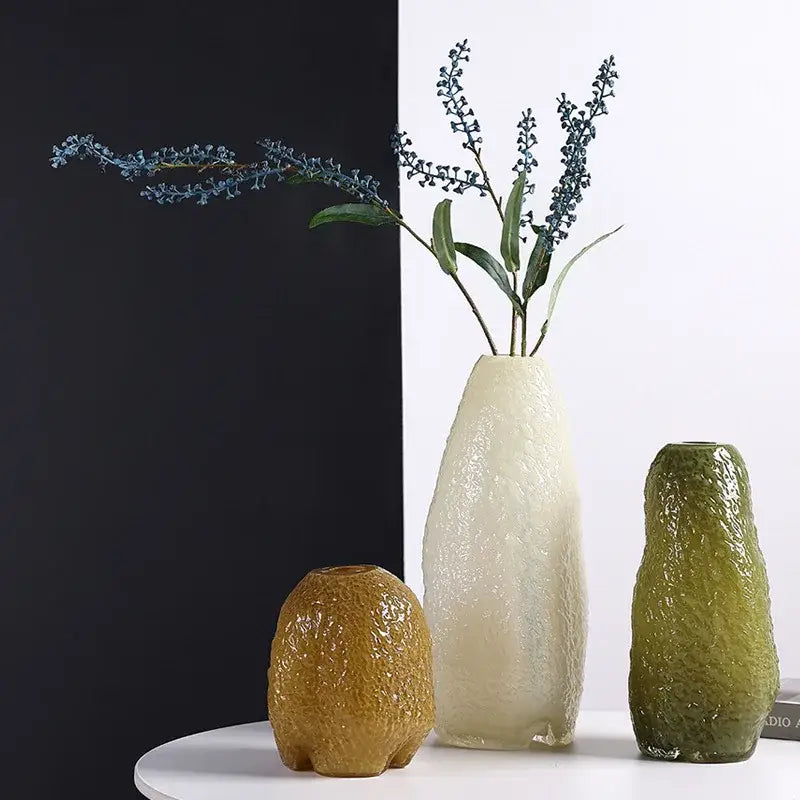 Cream-colored decorbites glass vase with irregular patterns and textured rippling surface for home decor and flower arrangement