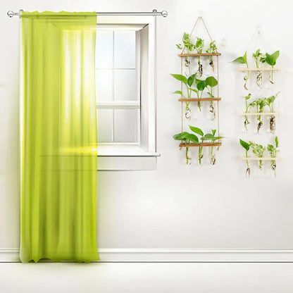 Lime green sheer curtain hanging from a silver rod beside DecorBites™ glass wall hanging planters with wooden holder and test tubes