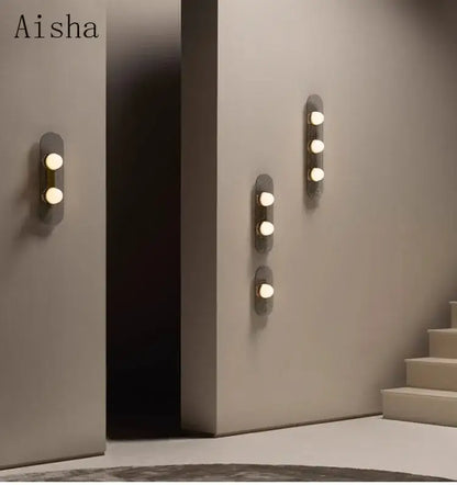 Modern minimalist decorbites glass wall lamp with three warm-toned bulbs on dark gray rectangular backplates for home decor