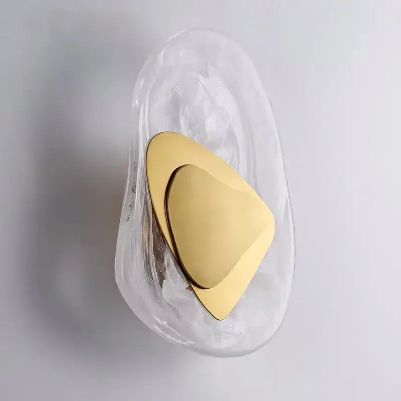 A sleek translucent glass wall lamp with polished gold triangular accent from DecorBites glass wall collection