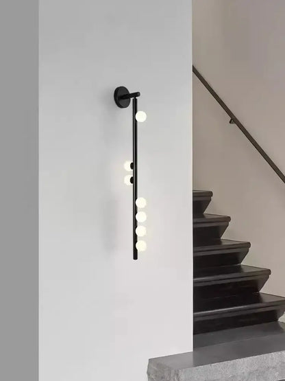 Black decorbites glass wall lamp with five glowing spherical bulbs on minimalist rod for modern living spaces