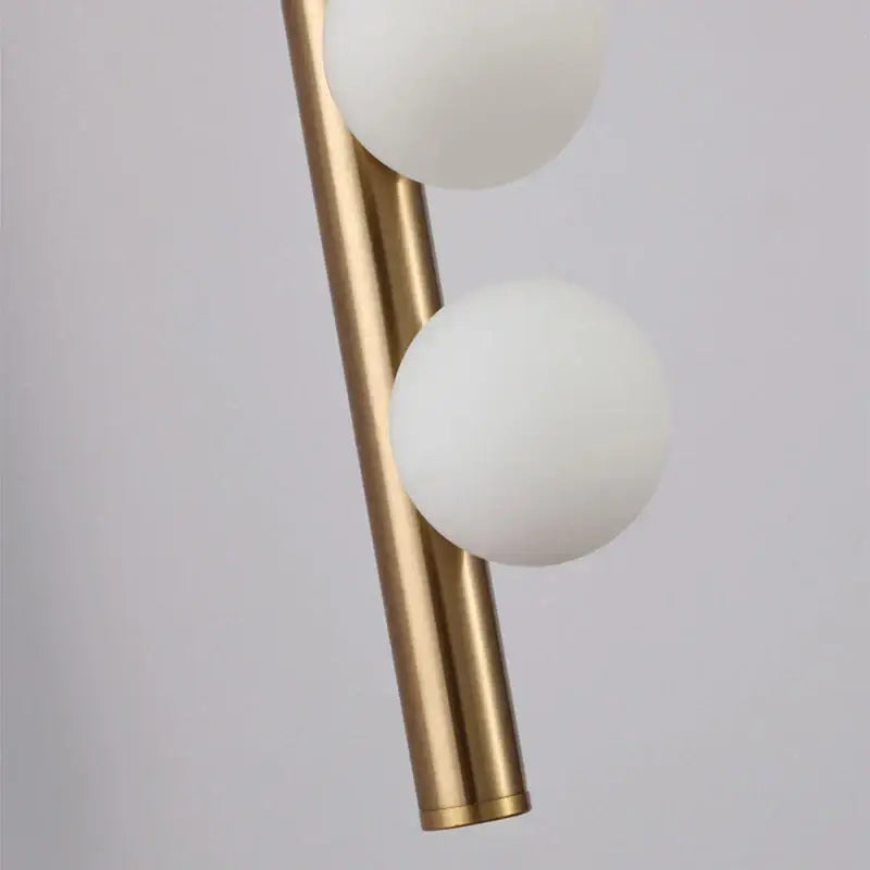 Modern brass-finished cylindrical decorbites glass wall lamp with two frosted white glass shades for living room and bedroom