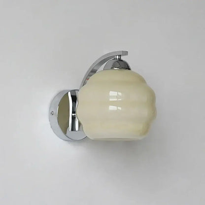 Cream-colored ribbed glass wall lamp with polished chrome bracket by DecorBites glass wall lamp for modern interiors