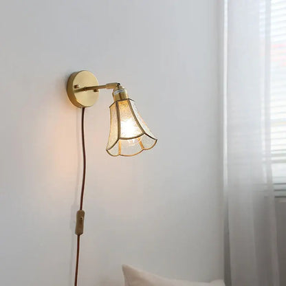 Gold-toned decorbites glass wall light sconce with textured glass shade and circular base for modern nordic lighting