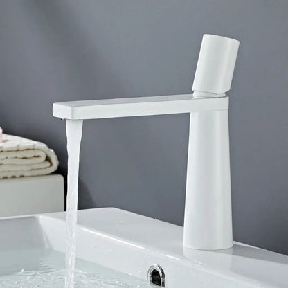 Modern white ceramic basin faucet with tall cylindrical base featuring brushed gold brass accents for bathroom sink