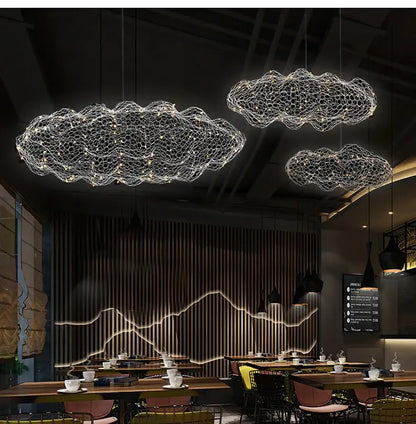 Three gold metallic wireframe cloud pendant lights illuminate ceiling perfect for home and restaurant decor