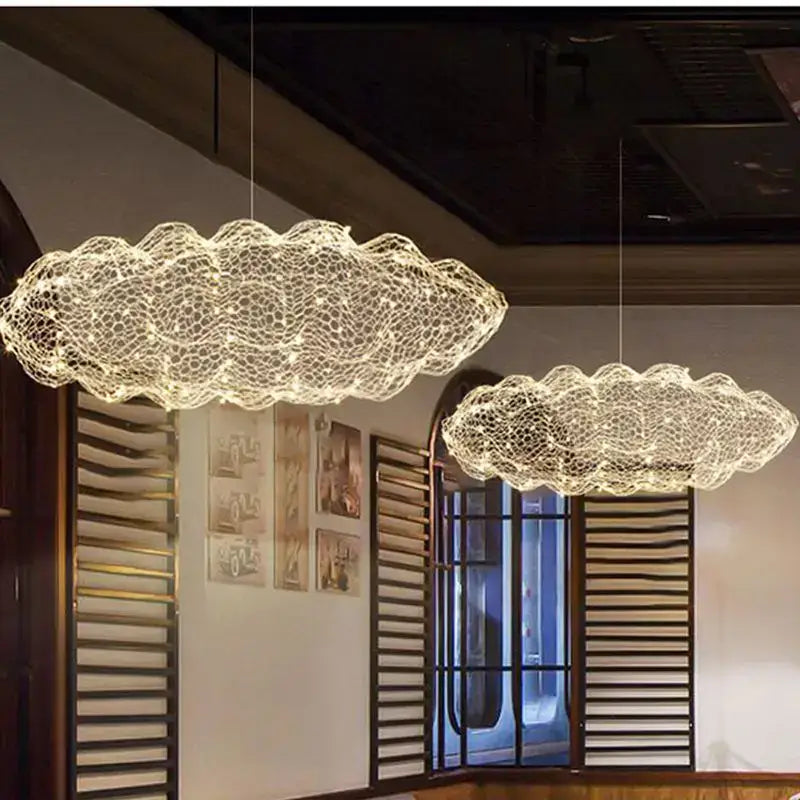 Two illuminated DecorBites gold cloud pendant lights with delicate woven wireframe design for home and restaurant use