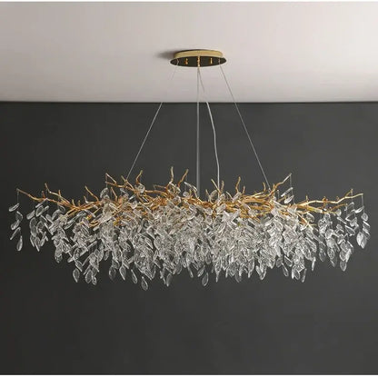 Elegant gold crystal led chandelier with cascading clear crystal leaves suspended from a circular ceiling mount