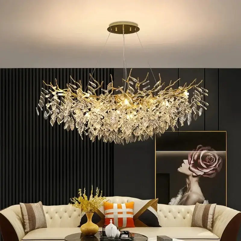 A gold crystal led chandelier in a leaf shape adorned with dangling crystal droplets for elegant home lighting