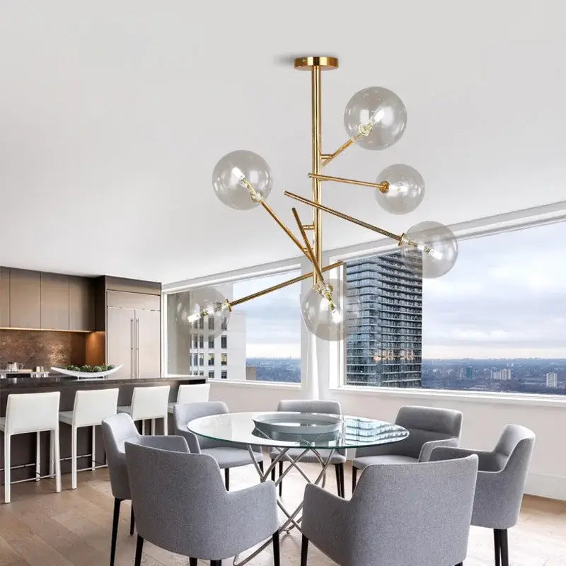 Gold-toned modern DecorBites™ chandelier featuring clear glass bubble bulbs for dining room lighting