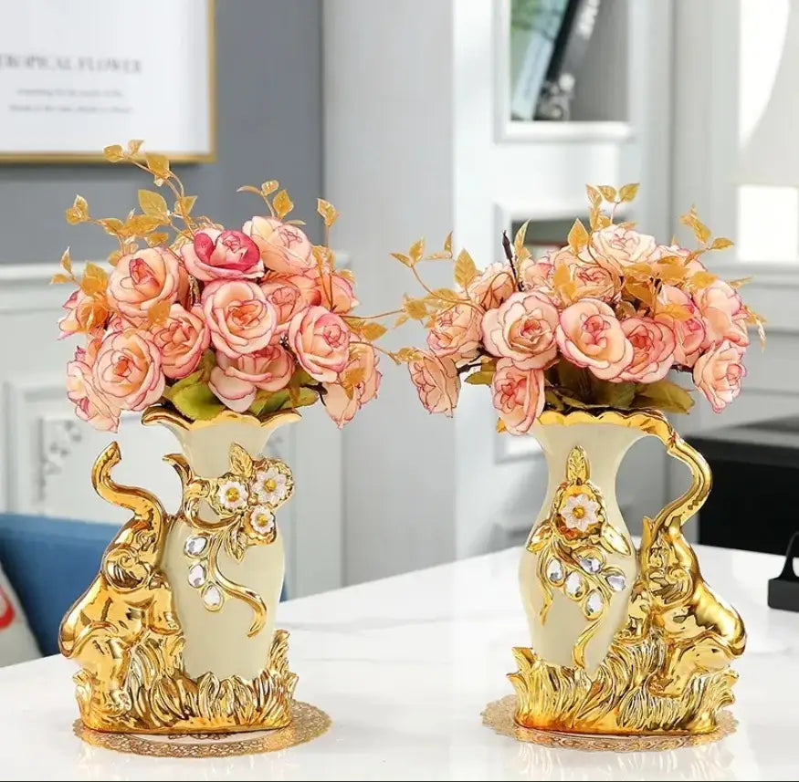 Cream-colored ceramic gold glass vase with gold elephant embellishments holding pink roses by DecorBites™