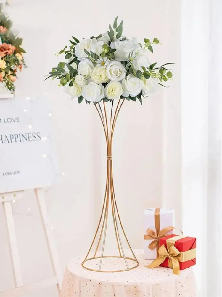 Elegant gold-toned iron flower vases by DecorBites holding white artificial roses for wedding decor
