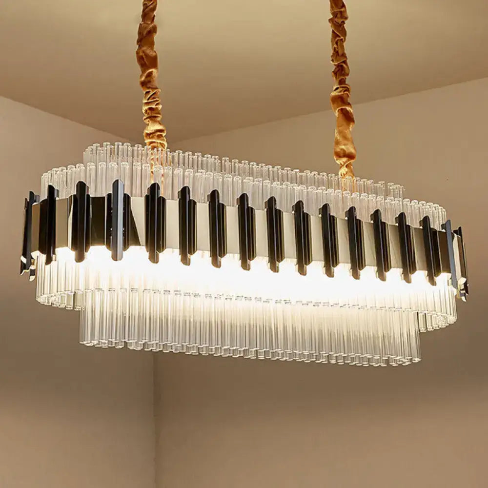 Decorbites gold led island chandelier featuring oval clear glass tubes with black metal accents and twisted gold cords