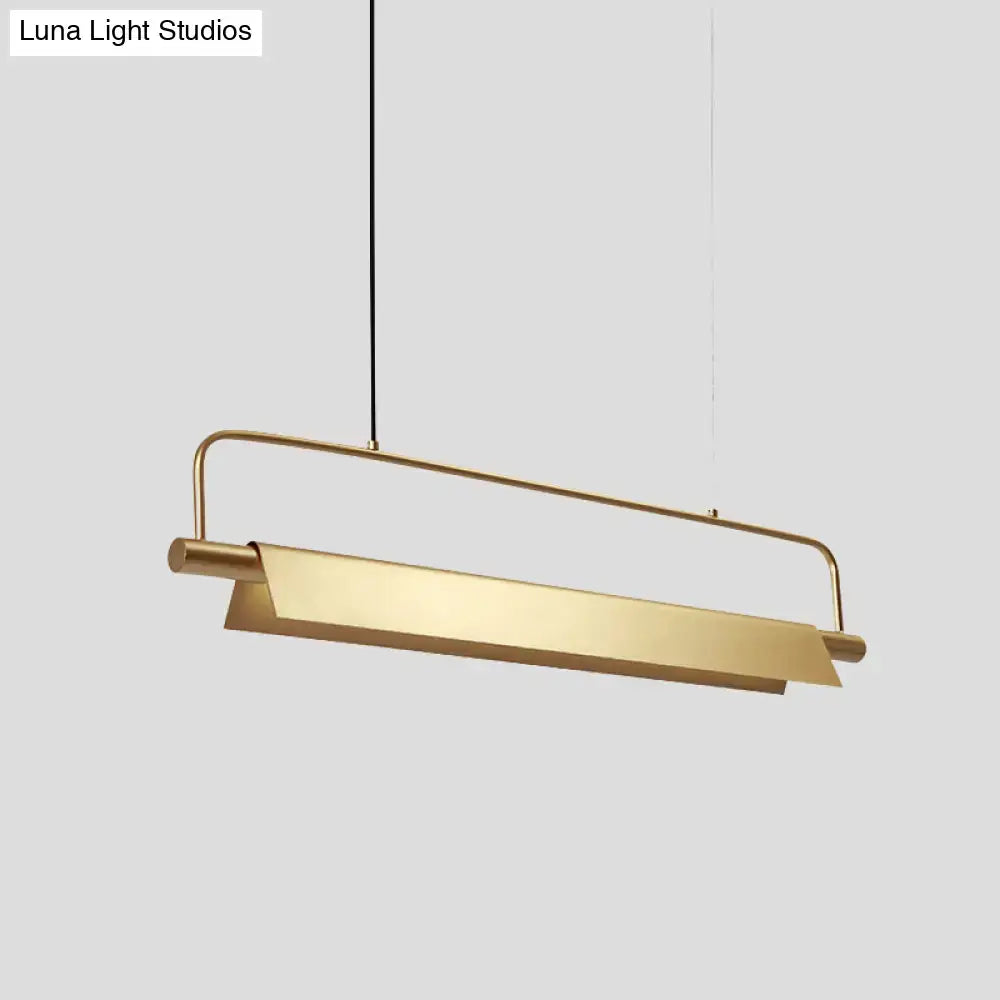 A sleek decorbites™ gold led island light fixture with brushed gold finish and minimalist metallic colonial design for restaurants