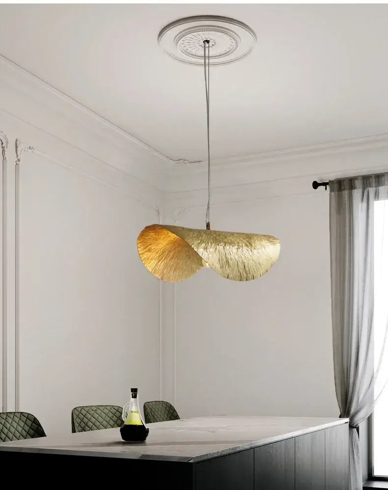 Decorbites gold lotus leaf pendant light with textured metallic finish hanging from ornate ceiling fixture