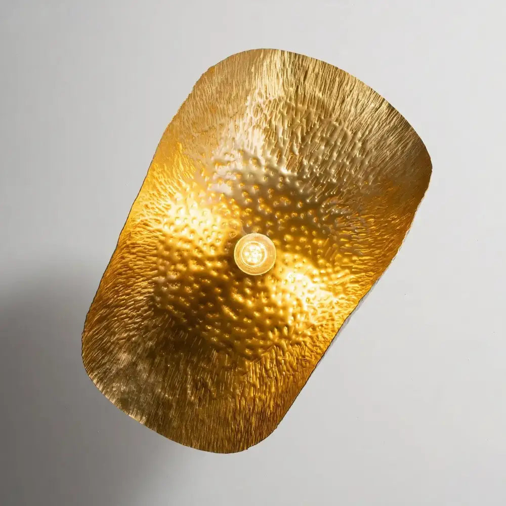 Gold lotus leaf pendant light with hammered metal texture and central bulb for modern decor lighting
