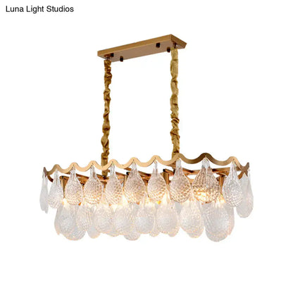 Gold-toned DecorBites island pendant with textured twisted chains and clear K9 crystal teardrops for dining room lighting
