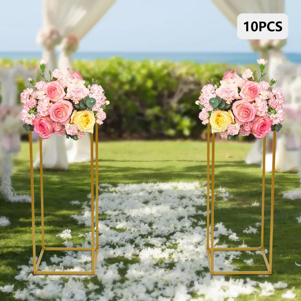 Decorbites™ gold metal wedding flower stand set featuring gold flower stands with pink and yellow rose bouquets and foliage