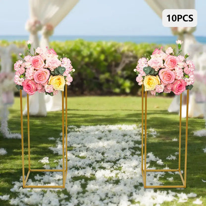 Decorbites™ gold metal wedding flower stand set featuring gold flower stands with pink and yellow rose bouquets and foliage