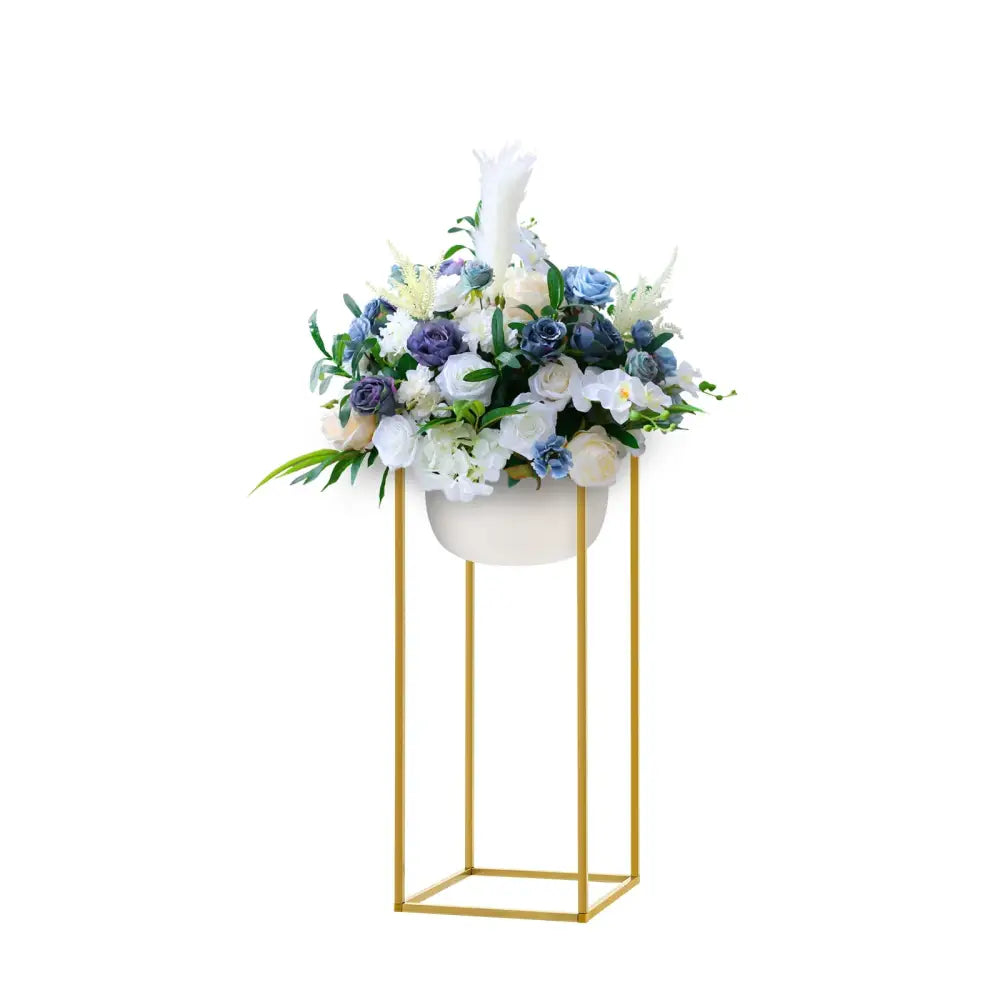 Elegant white ceramic planter with gold metal stand filled with blue and white flowers for wedding flower stand use