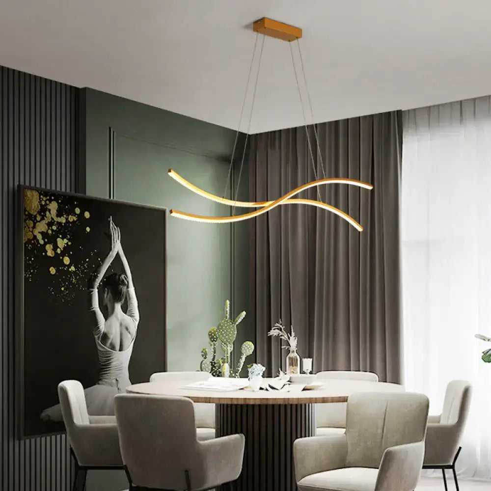 Modern gold-toned led hanging light with sleek curved arms and rectangular wooden ceiling mount for minimalist island ceiling use
