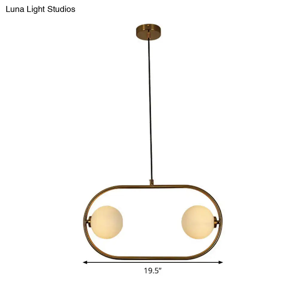 Modern globe hanging chandelier with brass frame and two frosted glass globe bulbs for bedroom lighting
