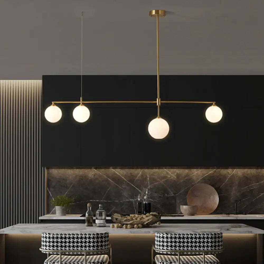 DecorBites™ gold-toned ceiling light with four frosted globe shades for dining room simplicity ball island fixture