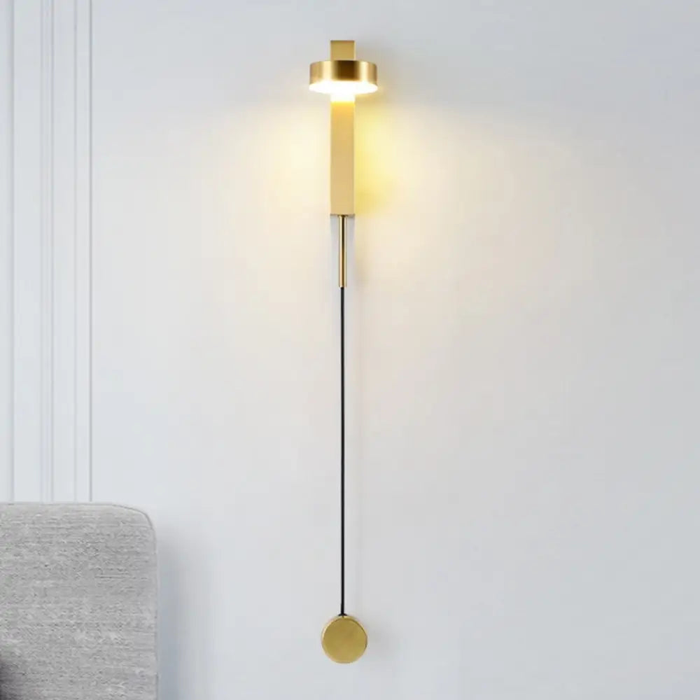 DecorBites™ gold wall lamp with dimmer switch features a minimalist gold-toned cylindrical light and circular base