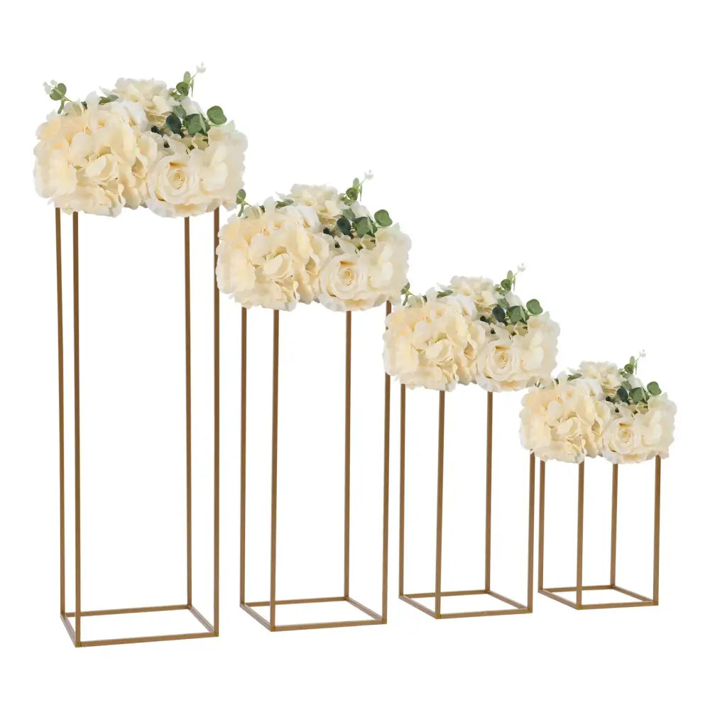 Set of four gold-toned metal flower vase stands with cream artificial flowers for elegant gold wedding decor by DecorBites™