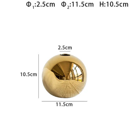 DecorBites golden ball ceramic vase is a shiny gold spherical home decor item with a smooth reflective surface and small opening