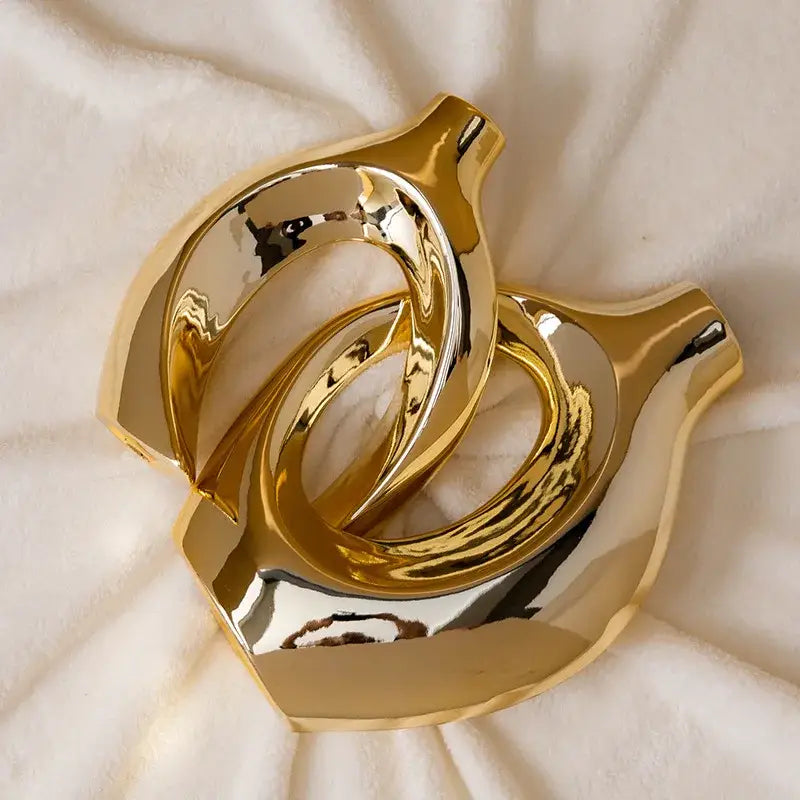 Shiny gold ceramic golden flower vase with interlocking ring-like forms from decorbites home decor accessory