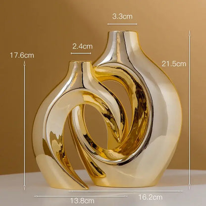 Shiny golden flower vase by decorbites featuring gold ceramic with abstract intertwined curves and a glossy finish