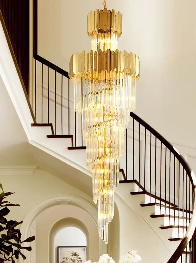 Golden chandelier with cascading crystal tiers and sleek modern design for decorbites golden luxury hotel lobby