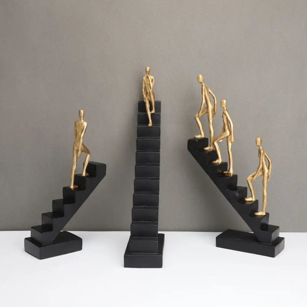 Set of three minimalist gold metal decorbites golden man climber staircase sculptures on black bases for home decor