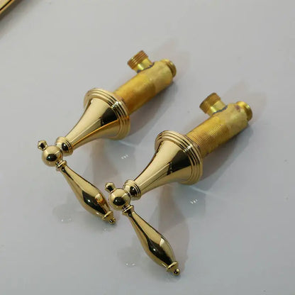 Pair of decorbites golden plated polished brass bathroom faucet handles with ornate tapered spout and ridged detailing