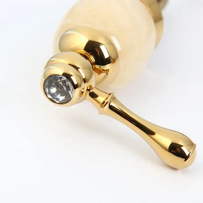 Decorbites golden plated waterfall bathtub faucet with gold finish, faceted crystal accent, and off-white ceramic handles
