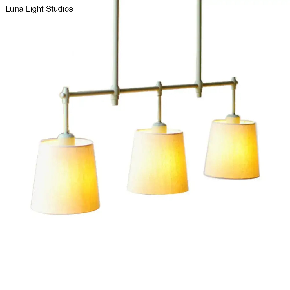 DecorBites Green Barrel fabric ceiling light with three warm-toned translucent shades on minimalist metal frame