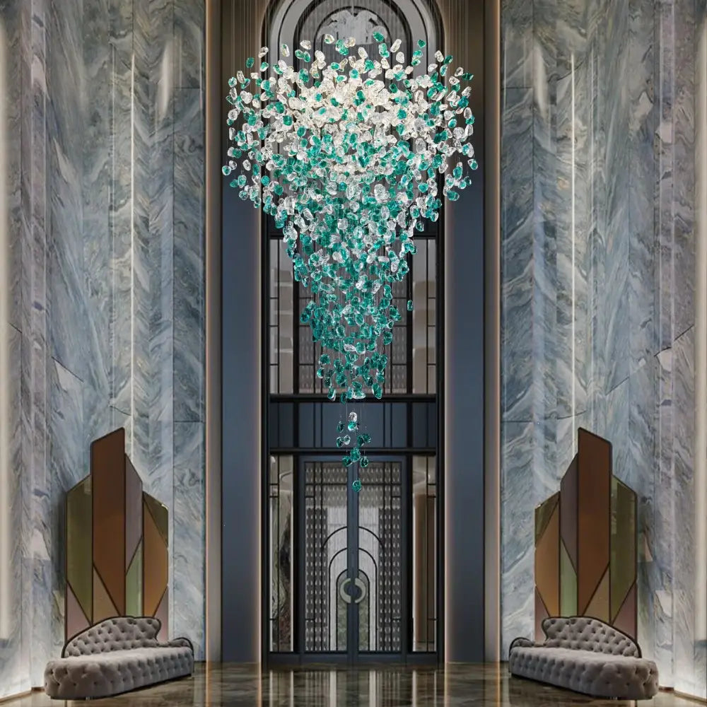 A cascading DecorBites™ chandelier with translucent green crystal stone droplets for modern luxurious spaces