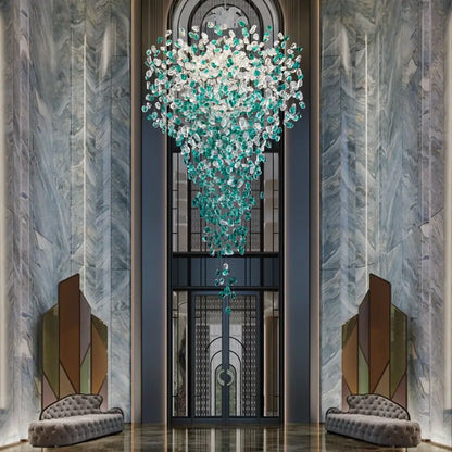 A cascading DecorBites™ chandelier with translucent green crystal stone droplets for modern luxurious spaces
