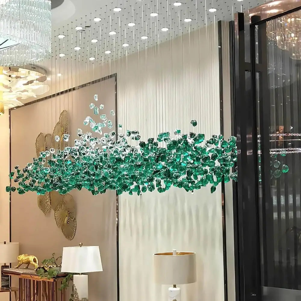 Emerald green crystal stone chandelier by decorbites with cascading leaf-like design for modern spaces