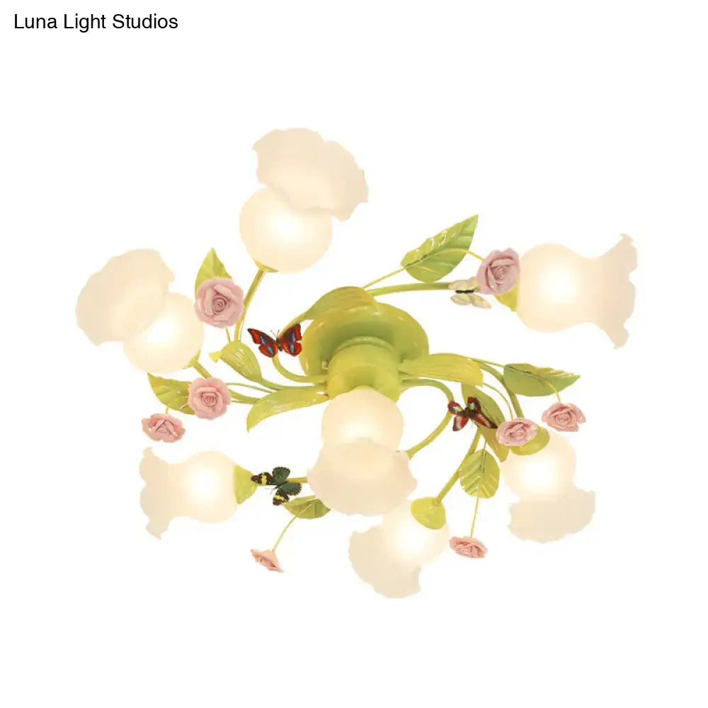 Decorbites green opaque glass spiral ceiling light fixture with pastel green and pink floral chandelier and butterfly accents