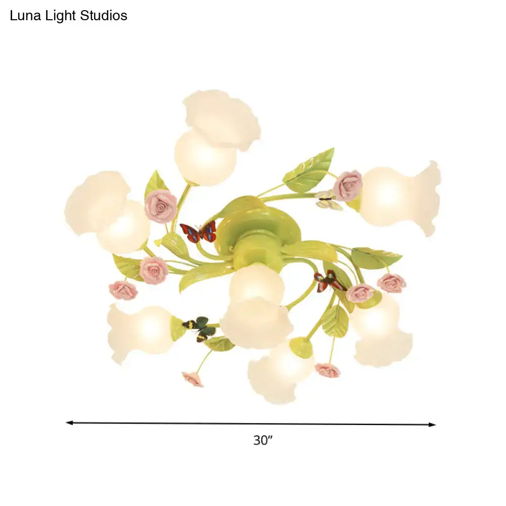 Decorbites green opaque glass spiral ceiling light fixture with pastel pink and green floral design and butterfly accents