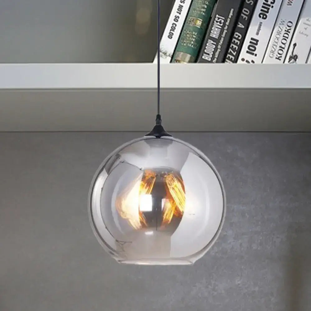 DecorBites™ grey glass pendant light with black fixture featuring a warm-toned filament bulb base for indoor use