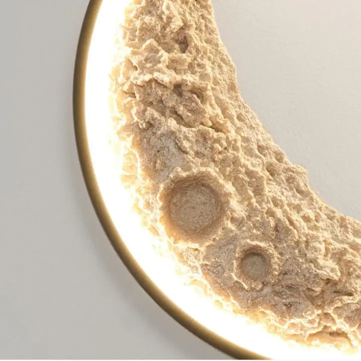 DecorBites half moon modern led wall lamp with textured beige surface and metallic gold rim illuminated crescent design