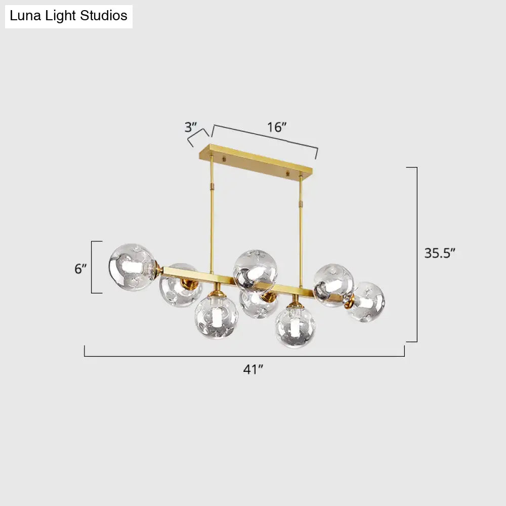 Gold-toned DecorBites™ modern chandelier with hand-blown dimpled glass globe bulbs for restaurant island pendant lamp