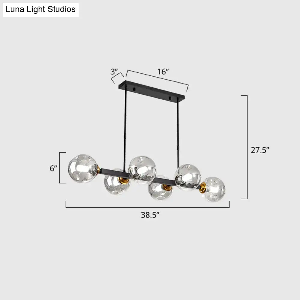 Modern black metal chandelier with five clear hand-blown dimpled glass bulbs and gold-toned accents for restaurant use