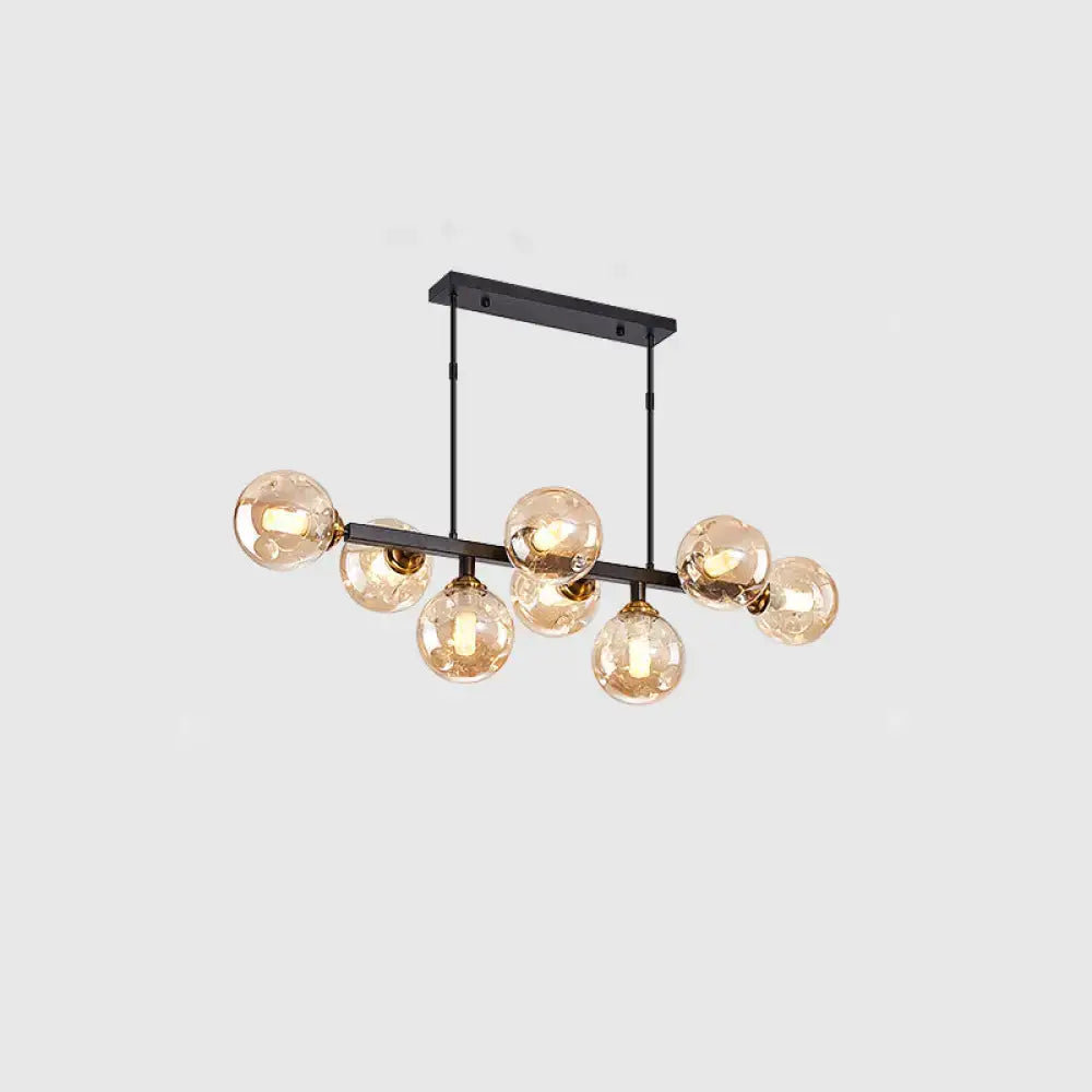 Modern black metal chandelier with seven amber hand-blown dimpled glass globe bulbs for restaurant lighting