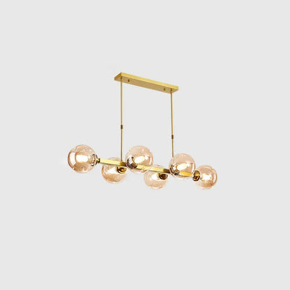Gold-toned DecorBites™ modern island pendant lamp with five hand-blown dimpled glass amber bulbs for restaurant use